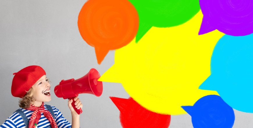 Happy child artist shouting by loudspeaker